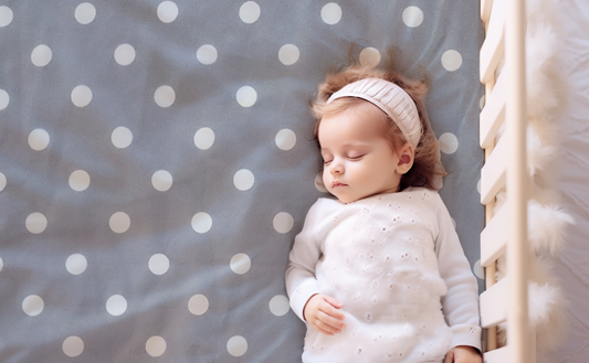 Organic Crib Sheet with White Polka Dots on a Gray Background